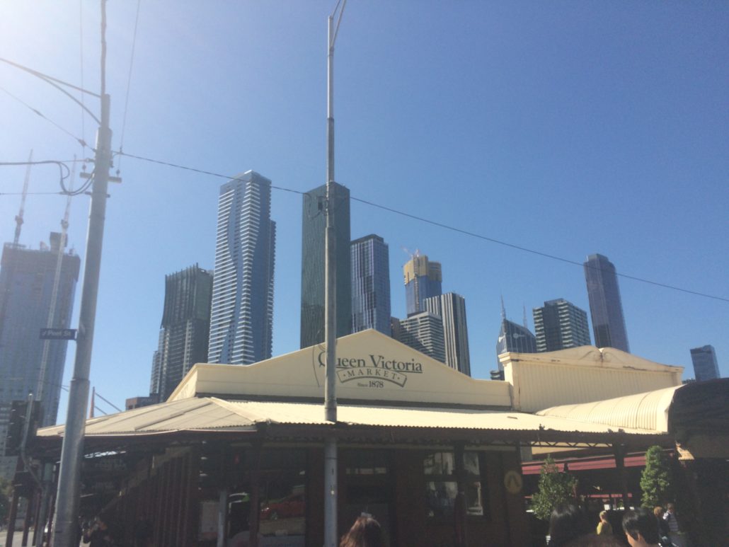 queen victoria markets, melbourne with skyscrapers in the background